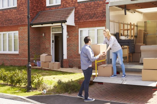 Moving van with recyclable boxes and reused household items in Surrey