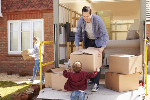 Removal van and moving boxes in a Surrey residential setting