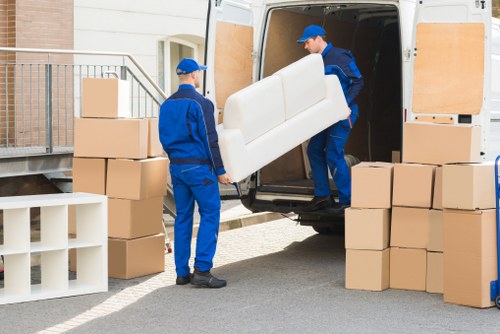 Man with van service moving household items into a van