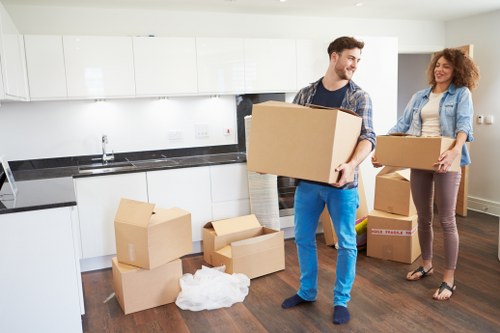 Family home relocation scene in Surrey with packed boxes and transport