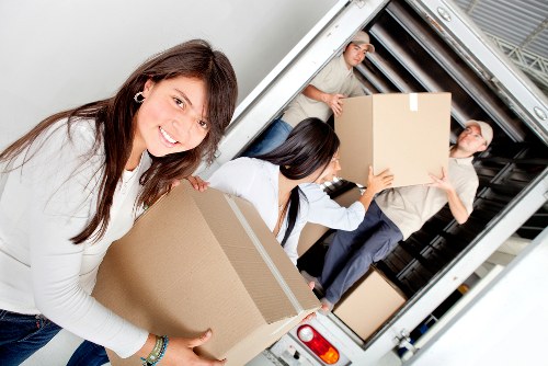 Loading furniture and boxes into a van for a Surrey local move